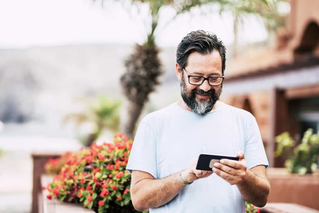 Happy adult man with beard and glasses