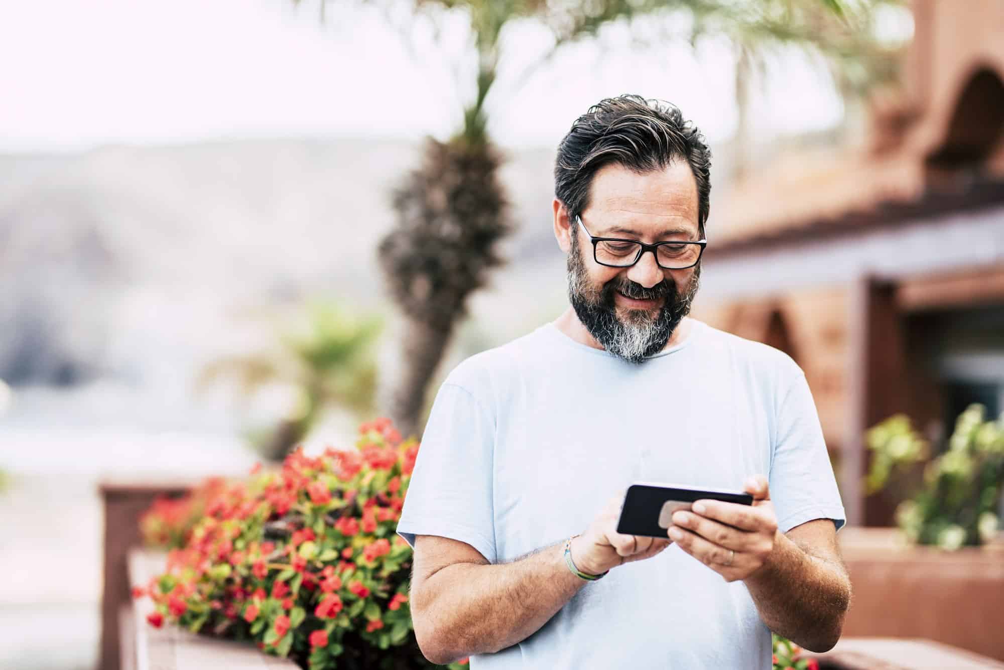 Happy adult man with beard and glasses